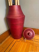 Red urn with lid shown separately, red with smooth finish
