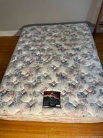 Top view of Searsopedic Sierra Plush Queen mattress with floral pastel pattern and central product label.