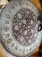 Full view of the 9 foot diameter round rug showing its overall design and colors.