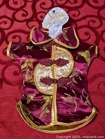 Front view of purple satin Chinese-style 10" doll dress with header card