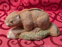 Full view of beaver coin bank showing overall form and flocked surface