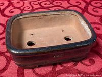 Top view of ceramic bonsai pot showing interior and drainage holes