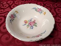 Top view of ceramic bowl showing floral pattern and scalloped rim