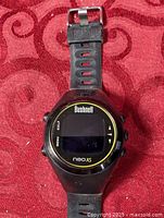 Front view of Bushnell Neo XS GPS watch showing screen and strap