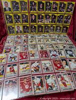 Assorted yellow-border junior league and red-border NHL hockey cards laid out on surface