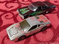 silver sports car and black sedan together