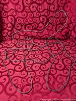 Full view of overlapping wire foot forms against patterned fabric