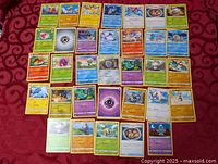 Full layout of all Pokémon cards on red cloth