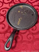 Top view of small cast iron skillet showing full cooking surface and handle