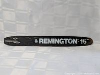 Full view of the Remington chainsaw bar with visible branding and size marking.