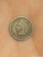 Obverse side of the 1893 Indian Head penny showing Lady Liberty profile with headdress, date and USA inscription.