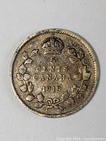 Obverse side of the 1919 Canadian 5 cents coin showing denomination and date.