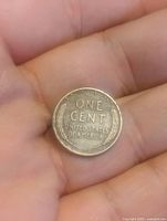Reverse side of the wheat cent coin showing 'ONE CENT UNITED STATES OF AMERICA' and wheat ear designs.