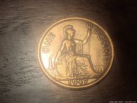 Reverse side of 1947 England large penny showing Britannia seated with trident, inscription ONE PENNY and date 1947