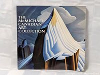 Front cover of The McMichael Canadian Art Collection book showing stylized artwork of a mountain landscape.