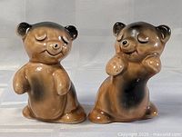 Front view of both hugging bear salt and pepper shakers showing their full height and posture.