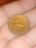 Front side of the coin showing Britannia seated, holding a trident and shield with 'HALF PENNY' and the year 1911.