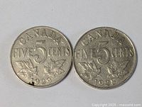 Two Canadian 5 cents coins dated 1929 and 1928 showing front side with 'CANADA', 'FIVE 5 CENTS', and two maple leaves.