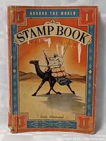 Front cover of the 'Around the World' stamp book showing a man on a camel in a desert, with the title prominently displayed.