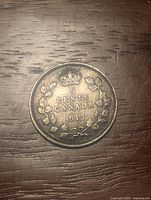 Reverse side of the 1913 Canadian 5 cent coin showing denomination, date, wreath and crown design.