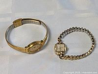 Two vintage ladies gold-tone watches side by side on a white surface, showing overall size and style.