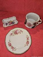 All three ceramic pieces: German cup, Wood's plate, Royal Crown Derby trinket dish