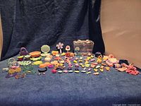 Full layout of all Littlest Pet Shop accessories and figures on blue background