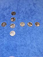 Eight quarters laid out on blue surface