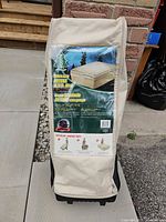 Front of beige wheeled carry bag showing product label