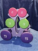 Front view showing all six dumbbells on stand