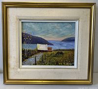 Frontal photo of the framed coastal oil painting showing the overall condition, composition and signature.