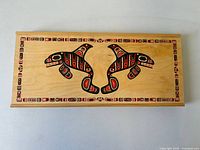 Top view showing the full artwork and shape of the rectangular wood box with Haida style design.