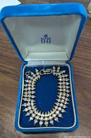 Signed Sherman rhinestone silvertone bracelet inside a Birks blue box, showing the overall design and presentation.
