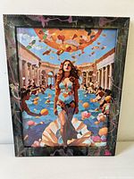 Frontal photo showing the full framed artwork with the woman walking on a shell, surrounded by petals and a crowd against columns.