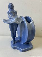 Front-left angle of the blue glazed ceramic Art Deco lady vase showing figure and vase form.