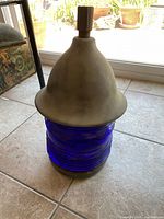 Full view of vintage runway light cap showing cobalt blue ribbed glass and weathered metal top.