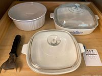 Top down photo showing three casserole dishes, two with lids and blue flower pattern, one without lid white ribbed.