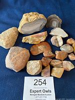 All decorative rocks and agates shown including various sized natural and polished stones with one rock possibly for hiding a key.