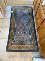 Full view of the floral floor rug showing entire length and patterns.