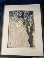 Full view of framed black and white woodblock print showing drooping cherry blossoms and full moon.