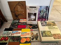 Photo showing 10 nature-related books laid out including Audubon Society field guides, home orchid growing book, foliage plants, and nature writing book.