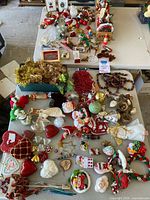 Full overview of the lot showing an assortment of vintage Christmas ornaments including glass baubles, felt figures, garlands, and framed artwork.