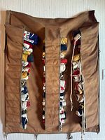 Full view of vintage International Code Signal Nautical Flags in original brown canvas holder with individual compartments and clips for hanging
