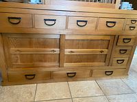 Front view of full cabinet showing drawers, sliding doors, and handles