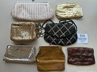 Full overview of six vintage handbags including metal mesh, beaded, leather styles
