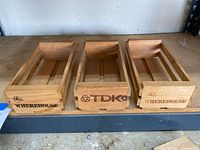 Front view showing three wooden cassette holders side by side, two with 'Wherehouse' branding and one with 'TDK' branding.