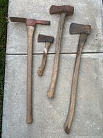 All five tools laid out on concrete slabs showing size and condition