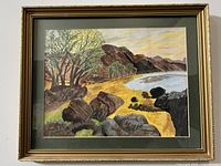 Frontal view of the framed abstract landscape painting showing detail of rocky shoreline, trees, hills and sky.