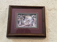 Frontal view of framed 3D art showing British antique store street scene with deep burgundy mat and dark wood frame.