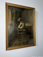 Framed antique painting showing a boy seated on a chair putting on his shoe in a muted color palette, signed by Dovenger.